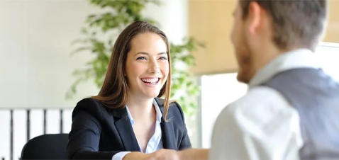 a woman smiling at a man