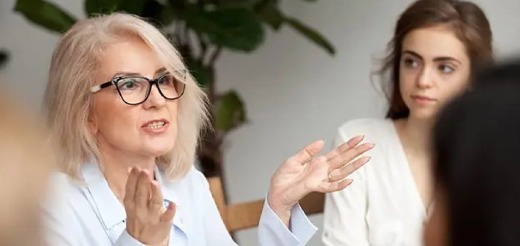 a woman talking to a group of people